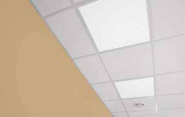 White ceiling with modern lighting in room, low angle view