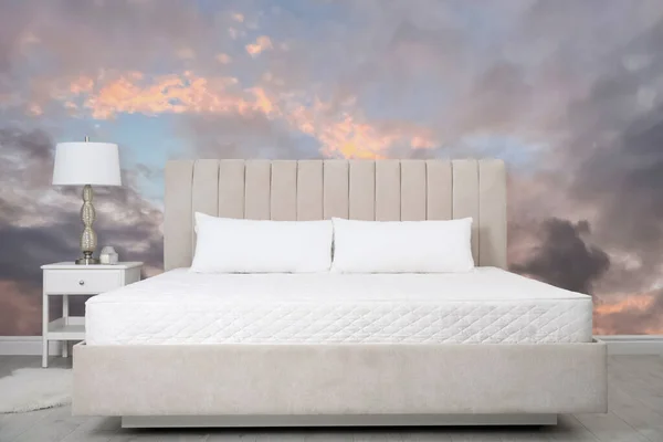 Pattern of sunset sky with clouds on wallpaper indoors. Beautiful bedroom interior