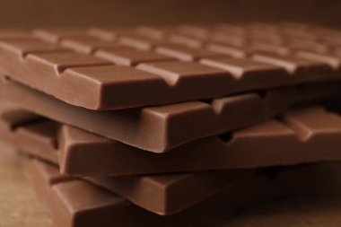 Tasty chocolate bars on wooden table, closeup
