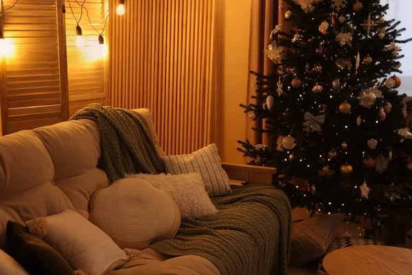 部屋のクリスマスツリーの近くの快適なソファ — ストック写真