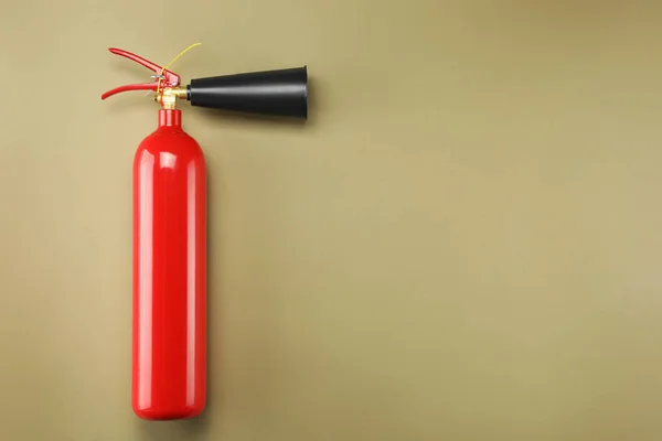 stock image Fire extinguisher on light brown background, top view. Space for text
