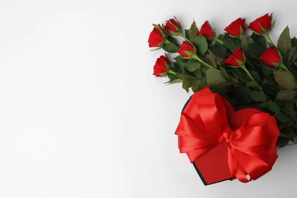 Pudełko Kształcie Serca Kokardą Pięknymi Czerwonymi Różami Białym Tle Płaskie — Zdjęcie stockowe