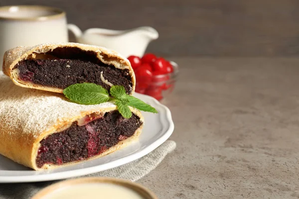 Stock image Delicious strudel with cherries and poppy seeds on grey table, closeup. Space for text