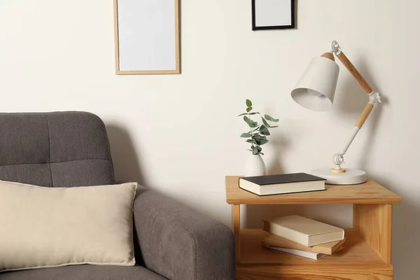 Stylish Modern Desk Lamp Book Plant Wooden Cabinet White Wall — Stock Photo, Image