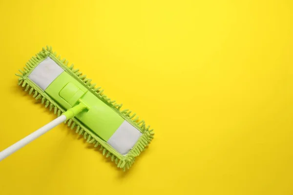 Mop Plastic Handle Yellow Background Top View Space Text — Stock Photo, Image