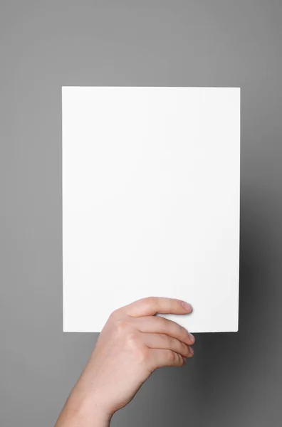 Woman Holding Sheet Paper Grey Background Closeup Mockup Design — Φωτογραφία Αρχείου