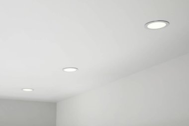 White ceiling with modern lighting in room, low angle view