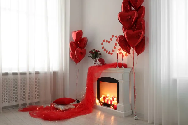 Stylish room with fireplace and Valentine's day decor. Interior design