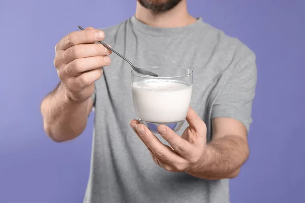 Man Med Läcker Yoghurt Och Sked Violett Bakgrund Närbild — Stockfoto