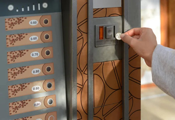 stock image Using coffee vending machine. Woman inserting coin to pay for drink, closeup