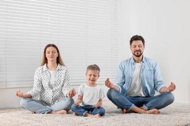 Aile evde meditasyon yapıyor. Ahenk ve zen