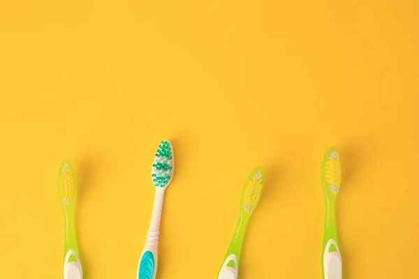 New Toothbrushes Yellow Background Flat Lay Space Text — Stock Photo, Image
