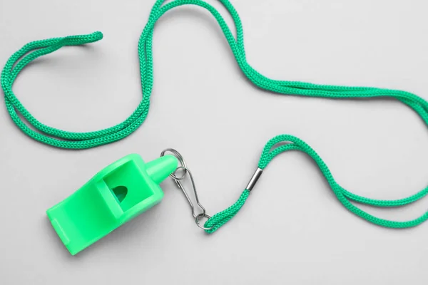 One Green Whistle Cord Light Grey Background Top View — Stock Photo, Image