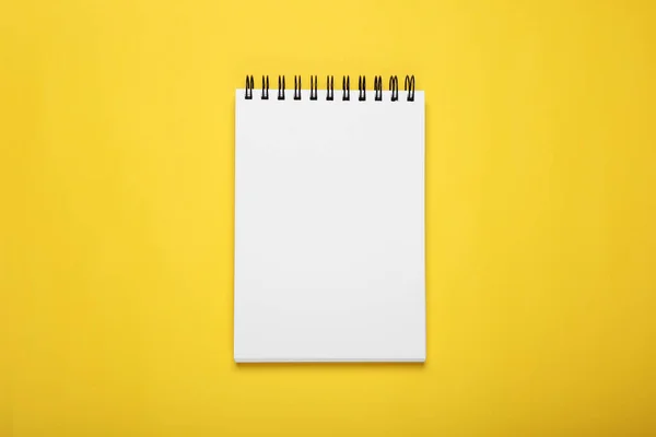 stock image Blank office notebook on yellow background, top view