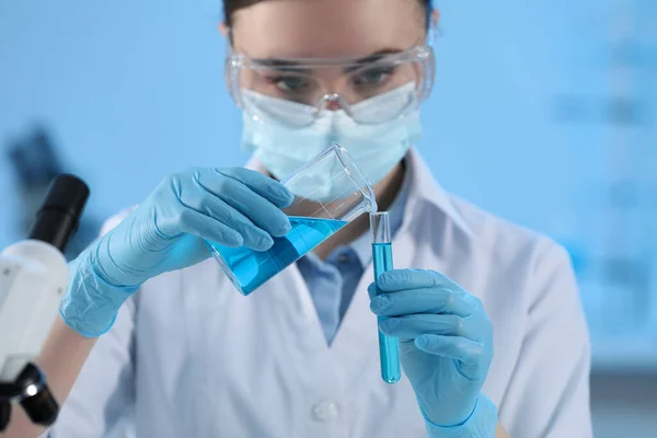 stock image Scientist working with beaker and test tube in laboratory, closeup