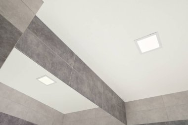 White ceiling with modern lighting in room, low angle view