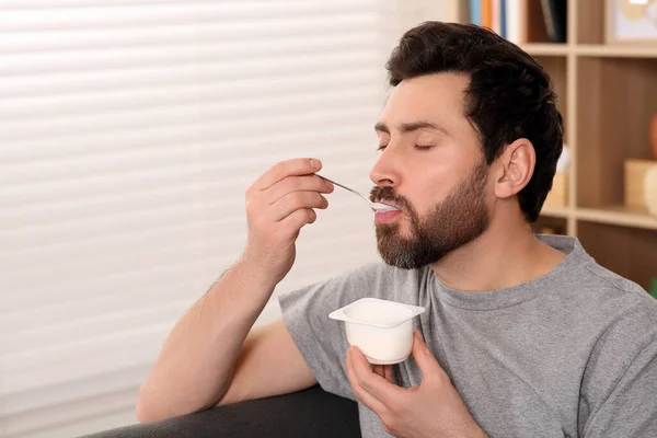 Bonito Homem Comendo Iogurte Delicioso Casa Espaço Para Texto — Fotografia de Stock