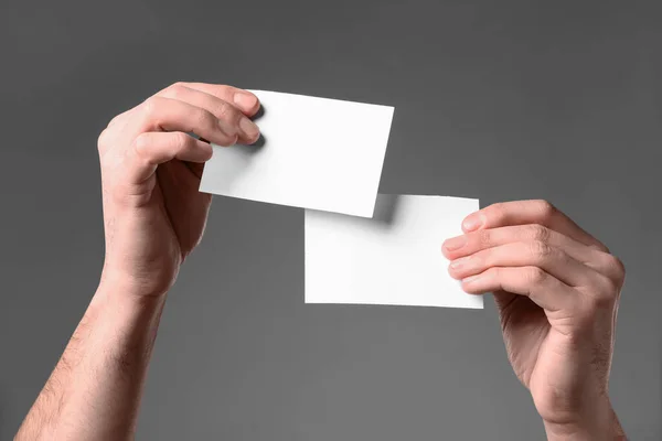 Man Holding Paper Cards Grey Background Closeup Mockup Design — Stock fotografie