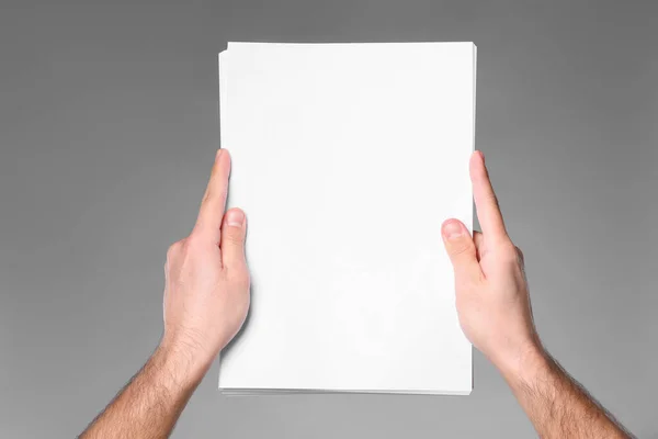 Man Holding Sheet Paper Grey Background Closeup Mockup Design —  Fotos de Stock