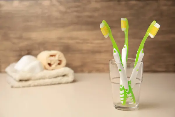 Toothbrushes Glass Beige Table Space Text — Stock Photo, Image