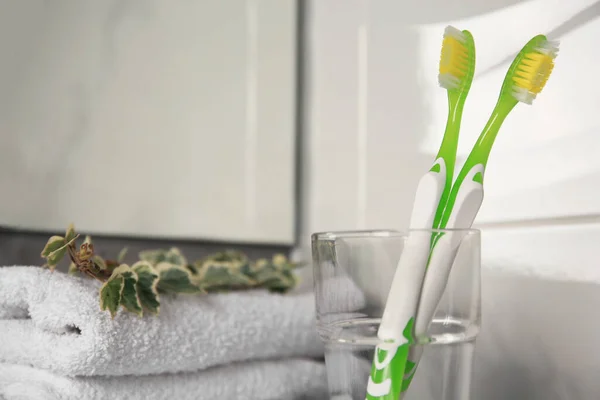 Two Light Green Toothbrushes Glass Holder Indoors — Stock Photo, Image