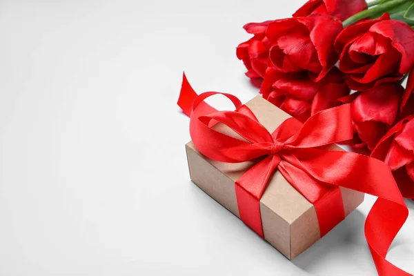 Schöne Geschenkschachtel Mit Schleife Und Roten Tulpenblumen Auf Weißem Hintergrund — Stockfoto