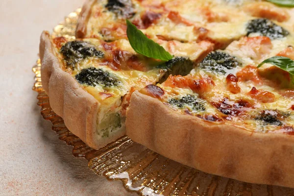 stock image Delicious homemade quiche with salmon and broccoli on beige table, closeup