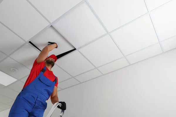 Electrician Repairing Ceiling Light Indoors Low Angle View Space Text — Stock Photo, Image