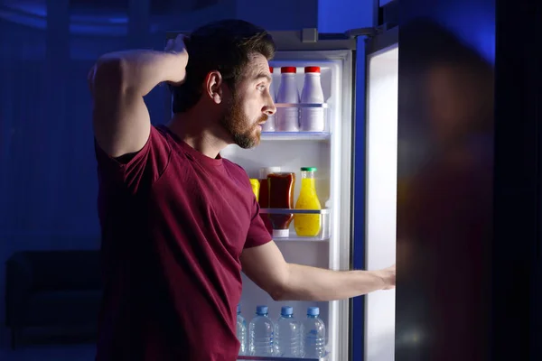 男人在晚上从厨房的冰箱里挑食 坏习惯 — 图库照片