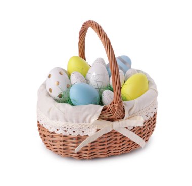 Wicker basket with beautifully painted Easter eggs isolated on white