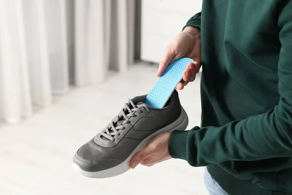 Man Putting Orthopedic Insole Shoe Indoors Closeup Space Text — Stock Photo, Image