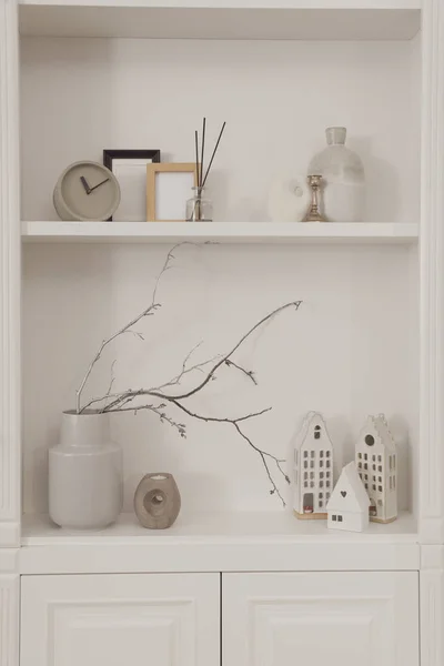 Stylish shelves with different decor elements. Interior design