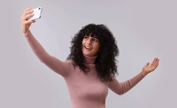 Όμορφη Νεαρή Γυναίκα Που Παίρνει Selfie Ανοιχτό Γκρι Φόντο — Φωτογραφία Αρχείου