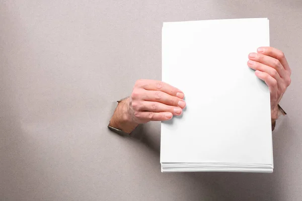 Man Holding Sheets Paper Holes White Paper Closeup Mockup Design — Stock fotografie