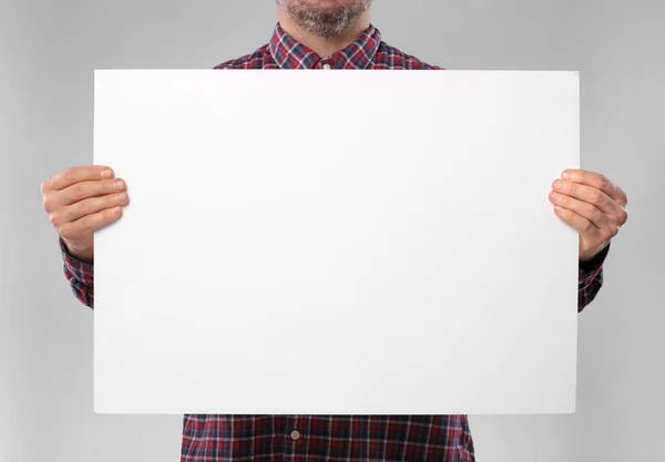 Man Holding Sheet Paper Grey Background Closeup Mockup Design — Stock Fotó