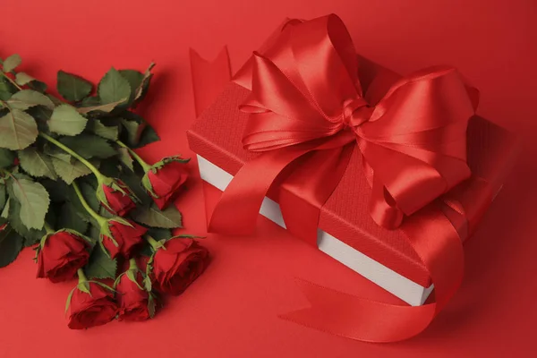 Schöne Geschenkschachtel Mit Schleife Und Rosen Auf Rotem Hintergrund — Stockfoto