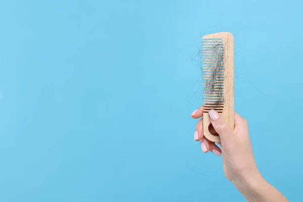 Woman Holding Comb Lost Hair Light Blue Background Closeup Space — Stock Photo, Image