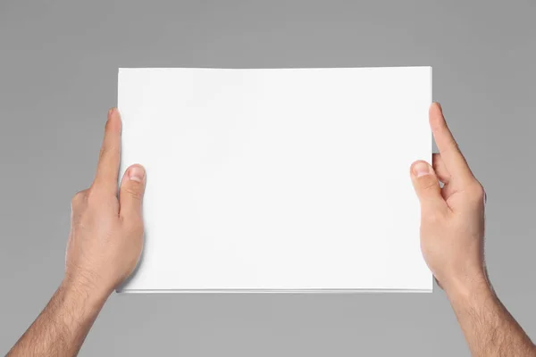 Man Holding Sheet Paper Grey Background Closeup Mockup Design —  Fotos de Stock