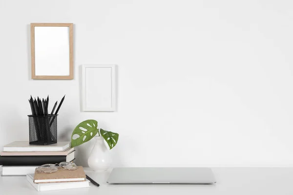 Stock image Cozy workspace with laptop, houseplant and stationery on white desk at home