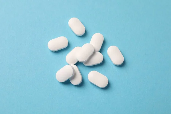 Stapel Weißer Pillen Auf Hellblauem Hintergrund Flache Lage — Stockfoto