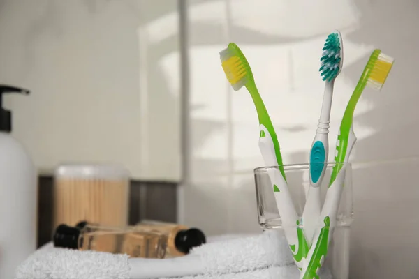 Light Blue Green Toothbrushes Glass Holder Indoors Space Text — Stock Photo, Image