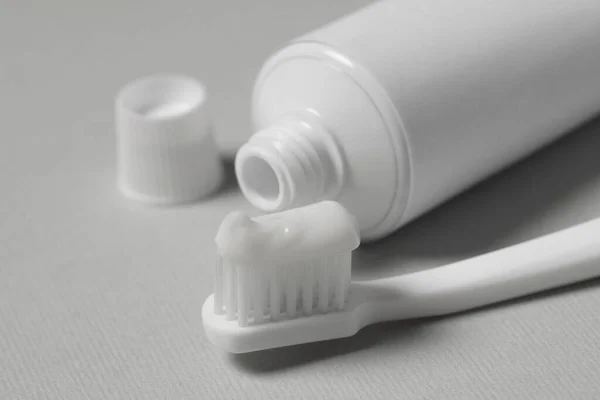 Plastic Toothbrush Paste Tube Grey Background Closeup — Stock Photo, Image