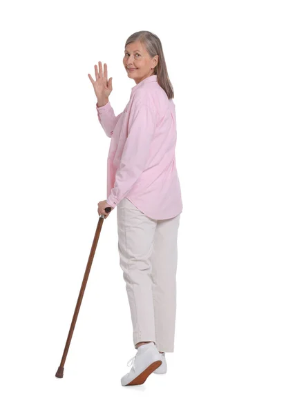 老女人 拿着手杖在白色背景上摇曳 — 图库照片
