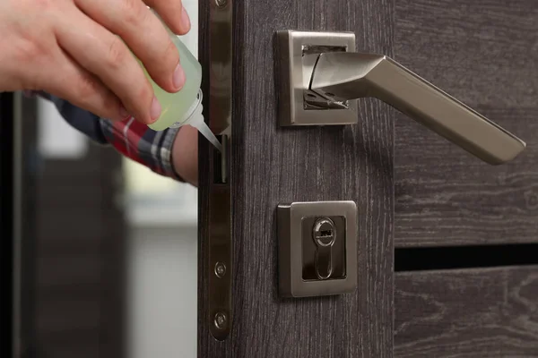 Handyman Lubricating Door Lock Oil Indoors Closeup — Stock Photo, Image