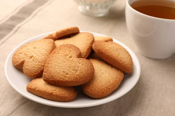 stock image Heart shaped Danish butter cookies and tea on table, closeup