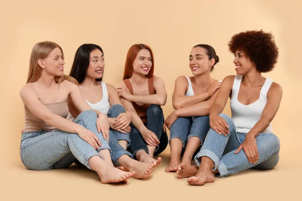 Grupo Hermosas Mujeres Jóvenes Sentadas Sobre Fondo Beige —  Fotos de Stock