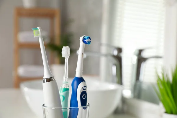 Electric Toothbrushes Glass Holder Indoors Closeup Space Text — Stock Photo, Image