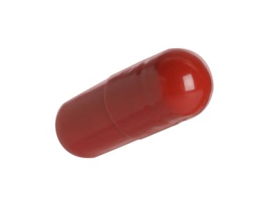 Beyaz arka planda bir kırmızı hap. Tıbbi tedavi