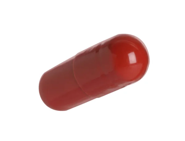 Una Pillola Rossa Sfondo Bianco Trattamento Farmacologico — Foto Stock