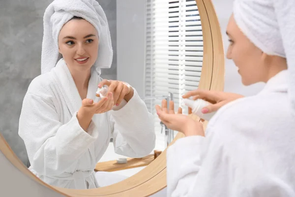 Beautiful Woman White Robe Applying Cream Mirror Indoors — Stock Photo, Image